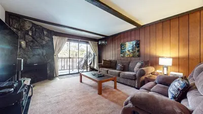 a living room with a couch and a fireplace at Summit #57 condo in Mammoth Lakes