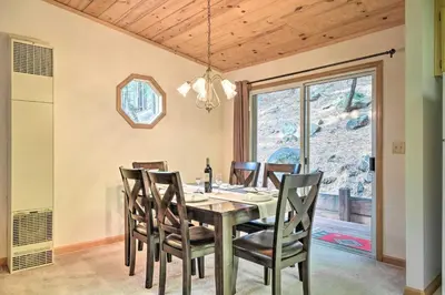 a dining room with a table and chairs at 4 Mi to Big Tree State Park Serene Cabin with Deck in Arnold