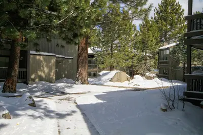 a driveway covered in snow next to a house at Sierra Park Villas 23 in Mammoth Lakes