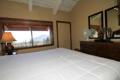 a bedroom with a large white bed and a window at Sierra Park Villas #67 in Mammoth Lakes