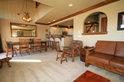 a living room with a couch and a table and chairs at Sierra Park Villas #67 in Mammoth Lakes