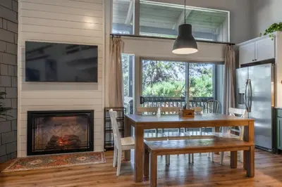 a dining room with a table and a fireplace at Sierra Park Villas 04 in Mammoth Lakes