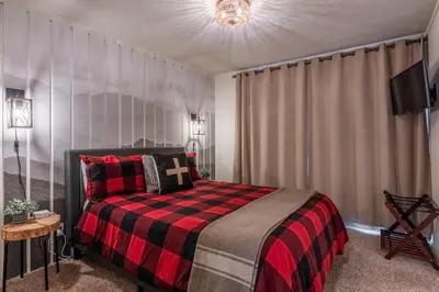 a bedroom with a bed with a red and black blanket at Sierra Park Villas 04 in Mammoth Lakes