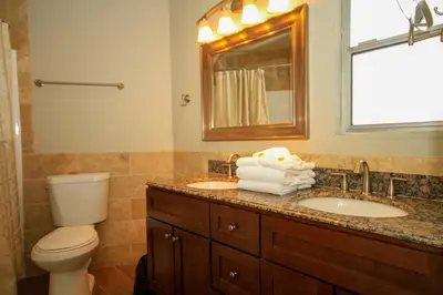 a bathroom with a toilet and a sink and a mirror at Sierra Park Villas 03 in Mammoth Lakes