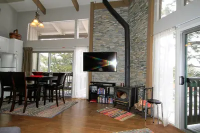 a living room with a table and a fireplace at Sierra Park Villas 03 in Mammoth Lakes