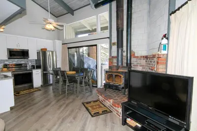 a living room with a large television and a fireplace at Sierra Park Villas 93 in Mammoth Lakes