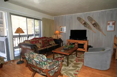 a living room with a couch and a tv at Sierra Park Villas 16 in Mammoth Lakes