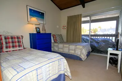 a bedroom with two beds and a window at Sierra Park Villas 16 in Mammoth Lakes