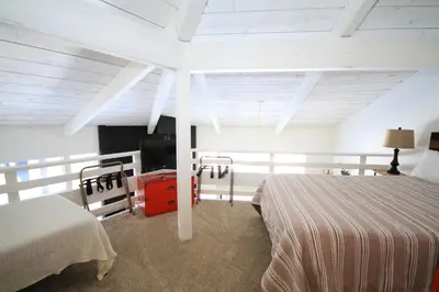 a bedroom with two beds and a television in it at Sierra Park Villas 89 in Mammoth Lakes