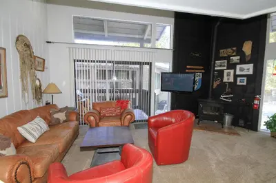 a living room with a couch and chairs and a television at Sierra Park Villas 89 in Mammoth Lakes