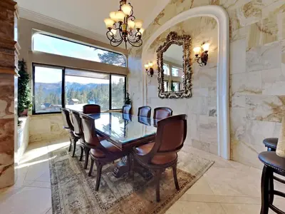 a dining room with a table and chairs and a mirror at 623 home in Mammoth Lakes