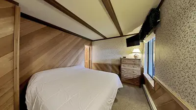 a bedroom with a bed and a dresser and a window at Comfortable 2 BR Loft Slope View Condo! in Mammoth Lakes
