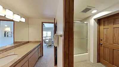 a bathroom with a sink and a shower and a mirror at Comfortable 2 BR Loft Slope View Condo! in Mammoth Lakes