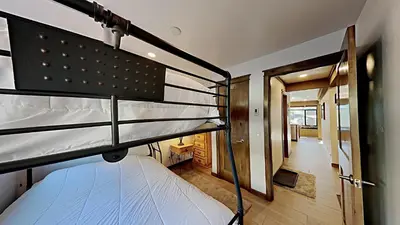 a room with two bunk beds and a hallway at Remodeled 2 Bedroom Condo with Amazing Views! in Mammoth Lakes