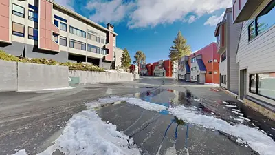 an empty street with snow on the ground at Spacious 2 Bedroom Home with Pool in Mammoth Lakes