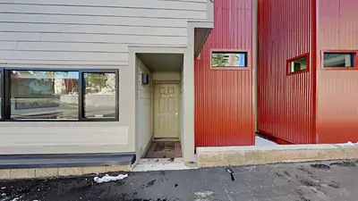a red and white building with a yellow door at Spacious 2 Bedroom Home with Pool in Mammoth Lakes
