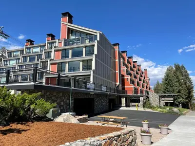 a large building with a bench in front of it at Spacious 2 Bedroom Home with Pool in Mammoth Lakes