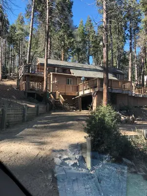 a large wooden house in the middle of a forest at sequoia National Forest CabinH in Panorama Heights