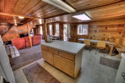 a kitchen and dining room in a log cabin at sequoia National Forest CabinH in Panorama Heights
