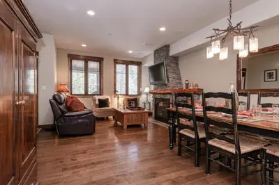 a kitchen and living room with a table and chairs at Woodwinds 22 in Mammoth Lakes