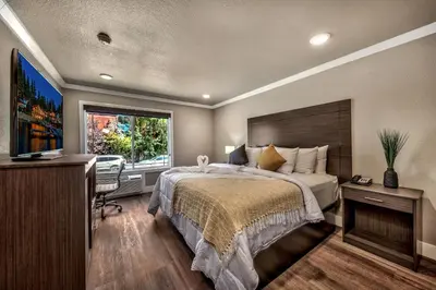 a bedroom with a bed and a desk and a television at The Elet Hotel in South Lake Tahoe