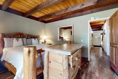 a bedroom with a bed and a wooden desk at North Lake Loft in Kings Beach