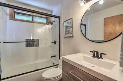 a bathroom with a sink and a toilet and a mirror at Tahoe Donner Retreat with Decks and Lake Access! in Truckee