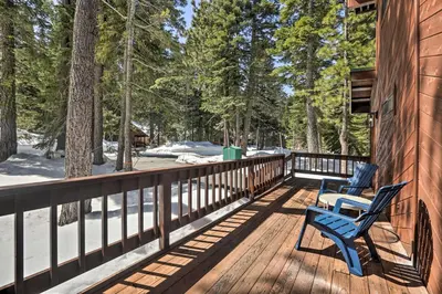 two blue chairs sitting on the deck of a cabin at Tahoe Donner Retreat with Decks and Lake Access! in Truckee
