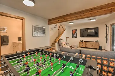 a living room with a table with a soccer game on it at Tahoe Donner Retreat with Decks and Lake Access! in Truckee