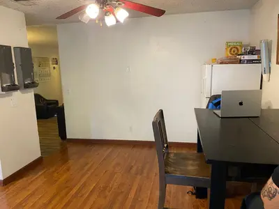 a dining room with a table with a laptop on it at WHOLE Family - Rosemont in Sacramento