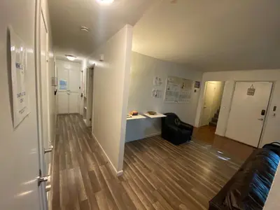 an empty room with a hallway with a desk at WHOLE Family - Rosemont in Sacramento