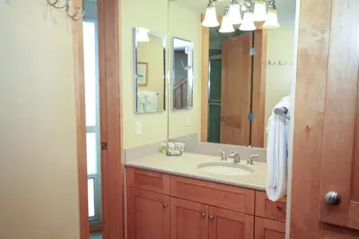 a bathroom with a sink and a large mirror at Sierra Park Villas 20 in Mammoth Lakes