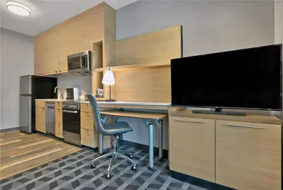 a room with a desk with a television and a chair at TownePlace Suites by Marriott Sacramento Elk Grove in Elk Grove