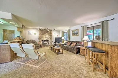 a living room with a couch and a fireplace at Home with Serene Deck in Twain Harte! in Twain Harte