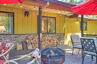 a patio with a fire pit in front of a house at Home with Serene Deck in Twain Harte! in Twain Harte