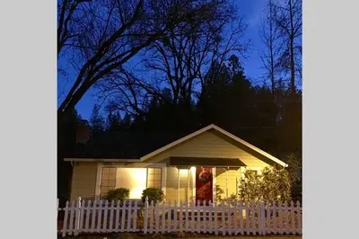 a santa claus standing in the window of a house at Vans Yosemite Garden Cottage in Groveland