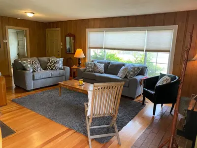 a living room with a couch and a table at Vans Yosemite Garden Cottage in Groveland