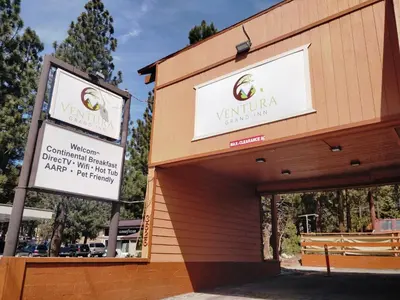 a building with two signs on the side of it at Ventura Grand Inn in Mammoth Lakes