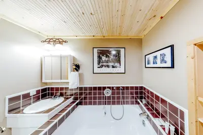 a bathroom with a tub and a sink at Under The Trees in Camp Connell