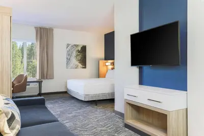 a hotel room with a bed and a flat screen tv at SpringHill Suites by Marriott Truckee Lake Tahoe in Truckee