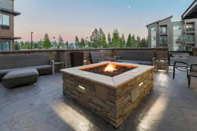 a patio with a fire pit on a building at SpringHill Suites by Marriott Truckee Lake Tahoe in Truckee