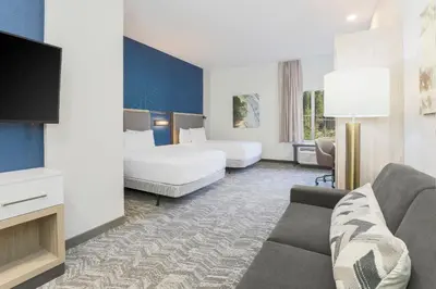 a hotel room with two beds and a couch at SpringHill Suites by Marriott Truckee Lake Tahoe in Truckee