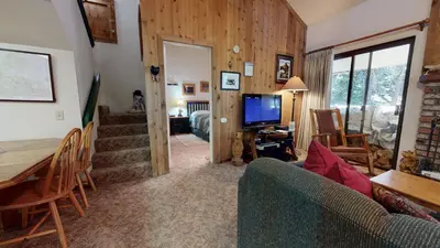 a living room with a couch and a table and a television at Hidden Valley #104 condo in Mammoth Lakes