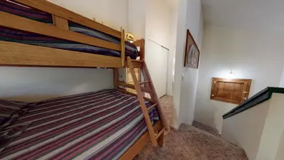 a bedroom with two bunk beds in a room at Hidden Valley #104 condo in Mammoth Lakes