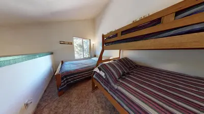 a bedroom with two bunk beds and a window at Hidden Valley #104 condo in Mammoth Lakes