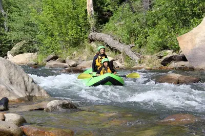 two people in a raft in a river at SoCal Camping in Kernville
