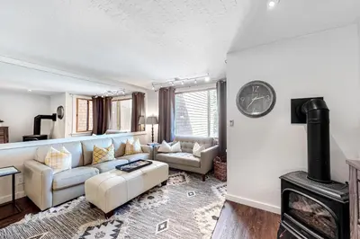 a living room with a couch and a fireplace at Cozy Coyote Fork Condo in Truckee