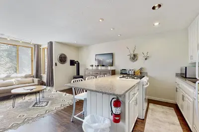 a kitchen and living room with a counter top at Cozy Coyote Fork Condo in Truckee