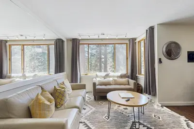 a living room with a couch and a table at Cozy Coyote Fork Condo in Truckee