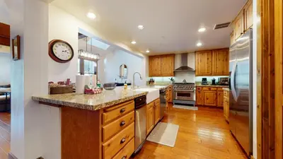 a large kitchen with wooden cabinets and a large counter top at Snowcreek The Lodges #1130 condo in Mammoth Lakes